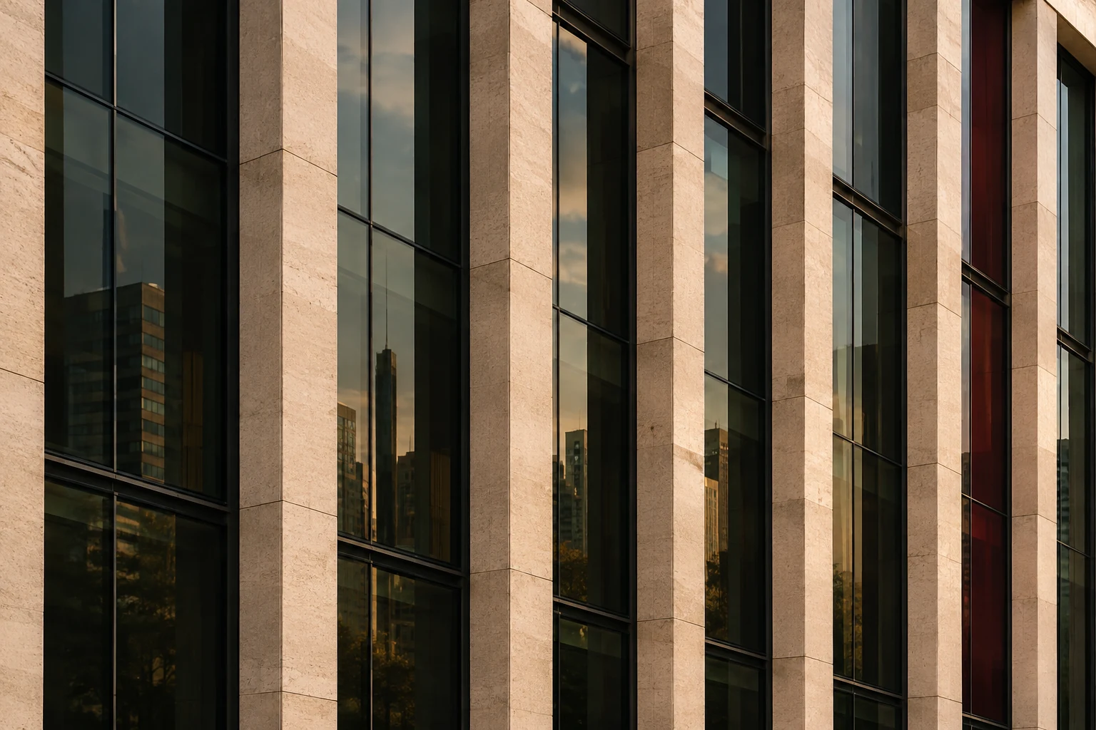 Fachada contemporánea de cristal y piedra con un ritmo de líneas verticales